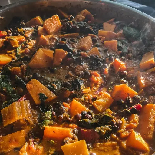 Spiced peanut stew with squash, carlin peas and winter greens